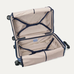 Interior view of the Travelpro Platinum Elite Medium Check-In Hardside Spinner in Dark Sky Blue, showing the adjustable hold-down straps and the spacious main compartment with ECOFAB™ lining.