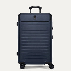 Travelpro Platinum Elite Medium Check-In Hardside Spinner in Aviator Navy, showing the adjustable PowerScope Lite handle, integrated TSA lock, and smooth-rolling dual spinner wheels.