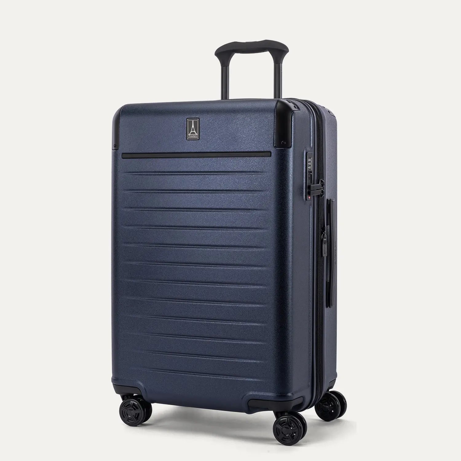 Three-quarter angled view of the Travelpro Platinum Elite Medium Check-In Hardside Spinner in Aviator Navy, showing the extended PowerScope Lite handle, integrated TSA lock, and dual spinner wheels.