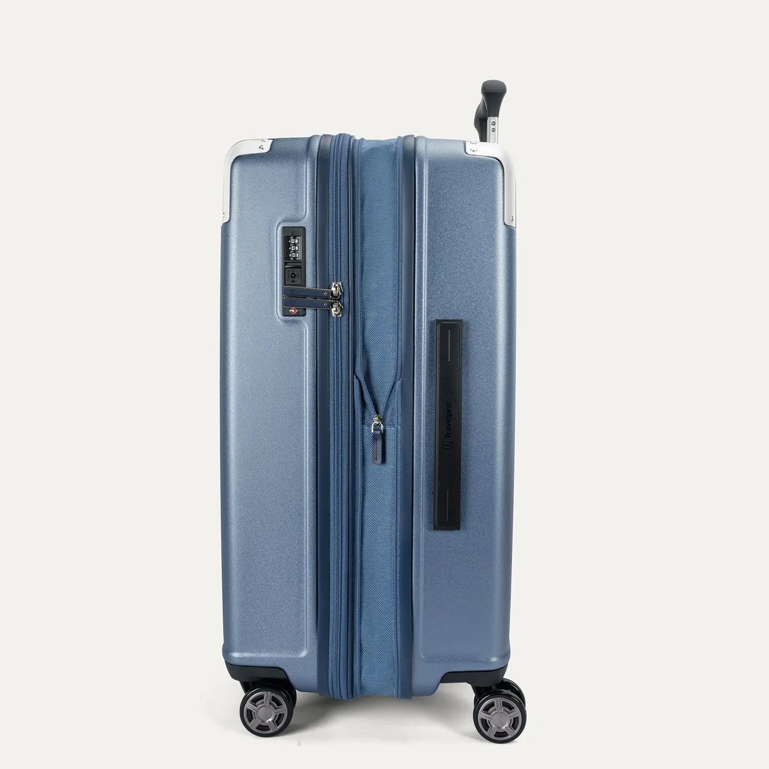 Side profile view of the Travelpro Platinum Elite Medium Check-In Hardside Spinner in Dark Sky Blue, showing the side carry handle, integrated TSA lock, and the slim profile of the polycarbonate shell.