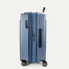 Side profile view of the Travelpro Platinum Elite Medium Check-In Hardside Spinner in Dark Sky Blue, showing the side carry handle, integrated TSA lock, and the slim profile of the polycarbonate shell.