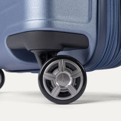 Close-up of the dual spinner wheels on the Travelpro Platinum Elite Medium Check-In Hardside Spinner in Dark Sky Blue, featuring the self-aligning MagnaTrac® technology and polished silver-tone wheel hubs.