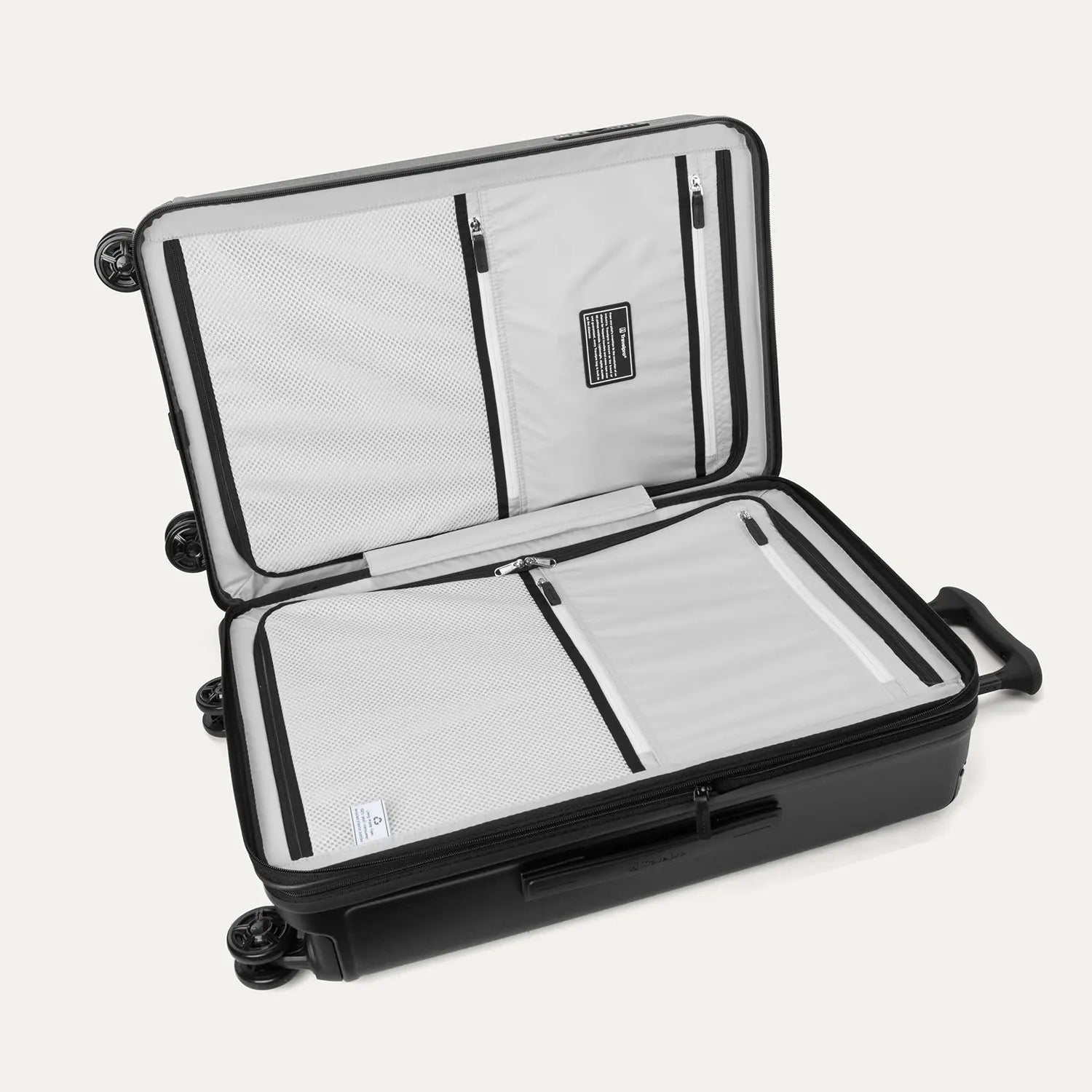 Interior view of the Travelpro Platinum Elite Medium Check-In Hardside Spinner in Jet Black, featuring dual zippered divider panels and the ECOFAB™ lining made from 100% recycled plastic bottles.