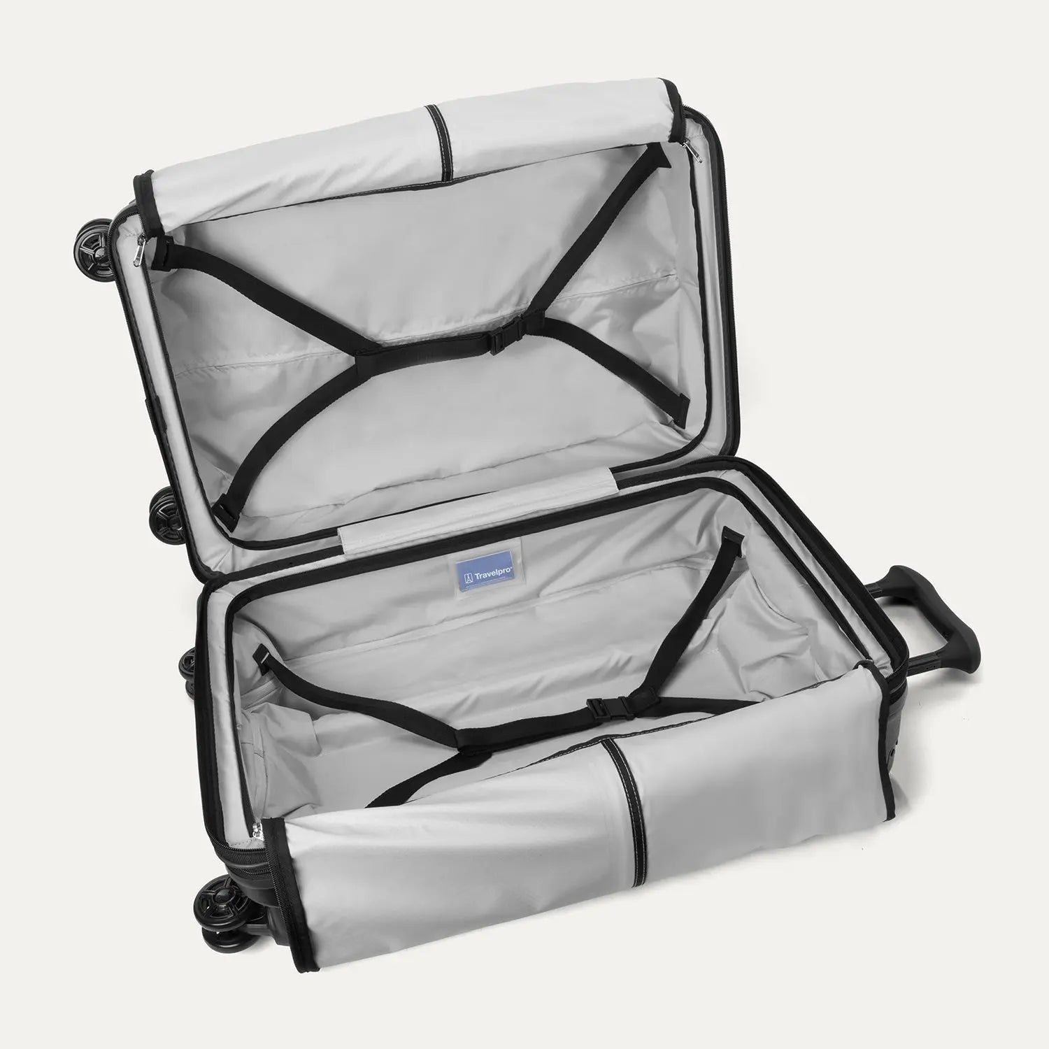 Fully open interior packing view of the Travelpro Platinum Elite Medium Check-In Hardside Spinner in Jet Black, showing the main compartment with adjustable hold-down straps and the ECOFAB™ lining.