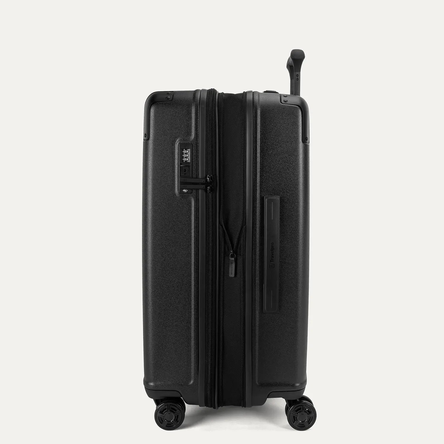 Side profile view of the Travelpro Platinum Elite Medium Check-In Hardside Spinner in Jet Black, showing the zippered expansion feature that provides 2 inches of additional packing capacity.