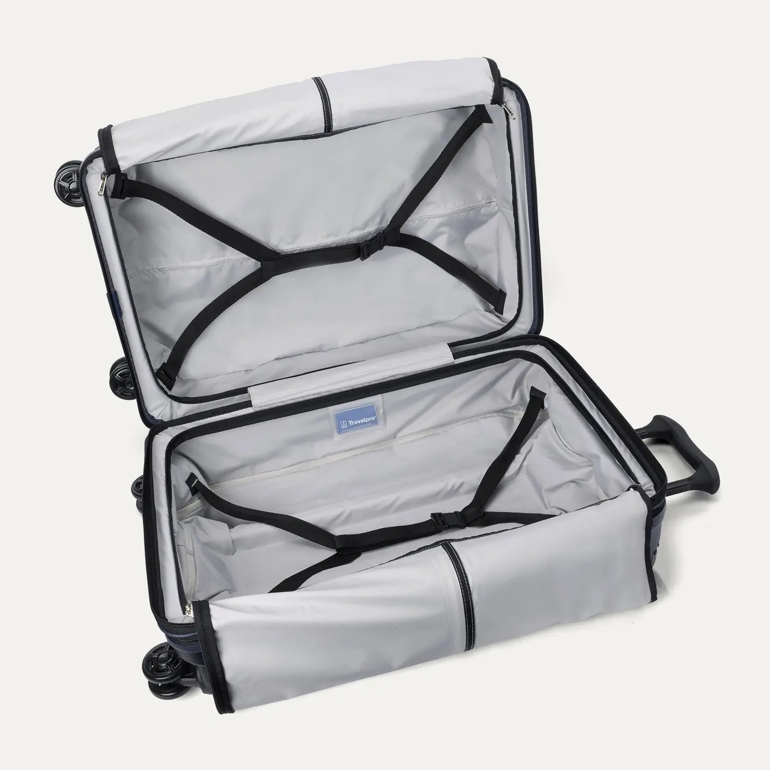 Fully open interior packing view of the Travelpro Platinum Elite Medium Check-In Hardside Spinner in Aviator Navy, showing the main compartment with adjustable hold-down straps and the ECOFAB™ lining.