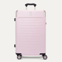  front view of the Travelpro Platinum Elite Medium Check-In Hardside Spinner in Powder Pink, featuring a durable polycarbonate shell with polished aluminum corner armor, an extended telescopic handle, and multi-directional wheels against a clean off-white background.