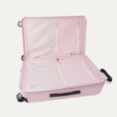 Interior view of the open Platinum® Elite Medium Check-In Hardside Spinner in Powder Pink, featuring zippered mesh compartments, packing panels, and the ECOFAB™ lining against a clean off-white background.