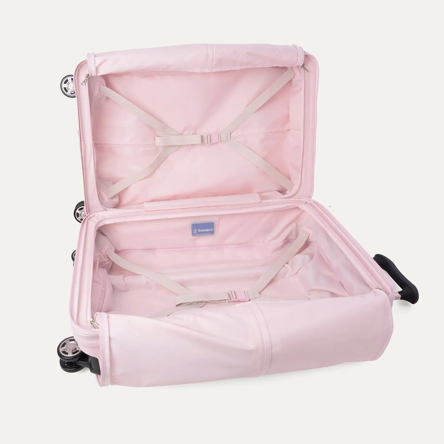 Interior view of the open Platinum® Elite Medium Check-In Hardside Spinner in Powder Pink, featuring zippered mesh compartments, packing panels, and the ECOFAB™ lining against a clean off-white background.