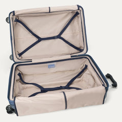 Fully open interior packing view of the Travelpro Platinum Elite Large Check-In Hardside Spinner in Dark Sky Blue, showing the main compartment with adjustable hold-down straps and the ECOFAB lining.
