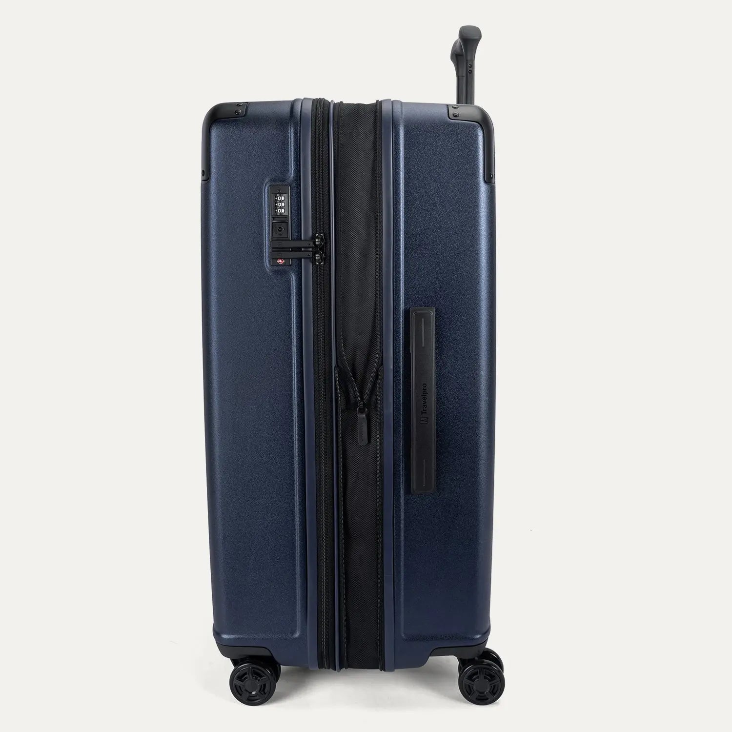 Side profile view of the Travelpro Platinum Elite Large Check-In Hardside Spinner in Aviator Navy, showing the zippered expansion feature that provides 2 inches of additional packing capacity.