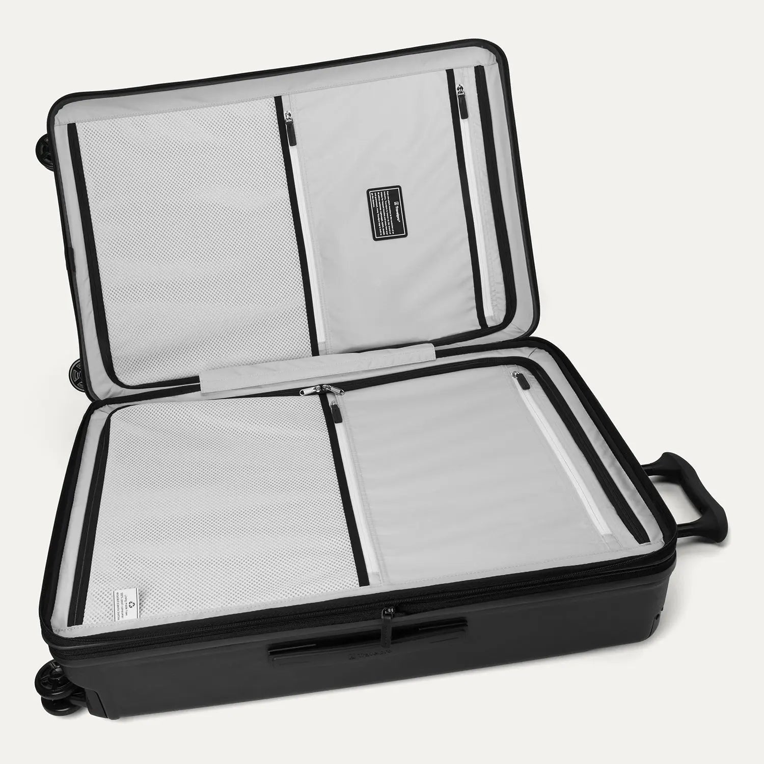 Interior view of the Travelpro Platinum Elite Large Check-In Hardside Spinner in Jet Black, featuring dual zippered divider panels and the ECOFAB™ lining made from recycled plastic bottles.