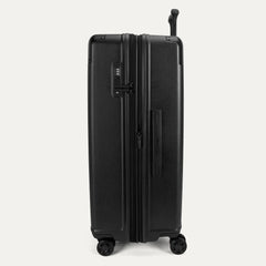 Side profile view of the Travelpro Platinum Elite Large Check-In Hardside Spinner in Jet Black, showing the expansion zipper, TSA-approved lock, and side carry handle.