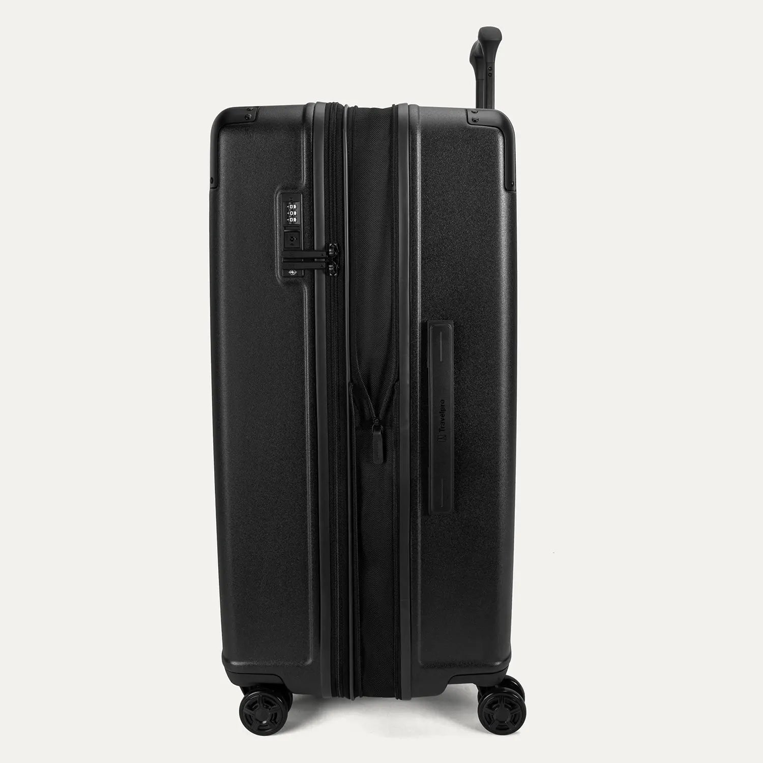 Side profile view of the Travelpro Platinum Elite Large Check-In Hardside Spinner in Jet Black, showing the 2-inch expansion zipper for additional packing capacity and the durable polycarbonate shell.