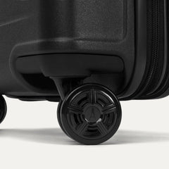 Close-up of the dual spinner wheels on the Travelpro Platinum Elite Large Check-In Hardside Spinner in Jet Black, featuring self-aligning MagnaTrac technology for straight tracking and effortless mobility.