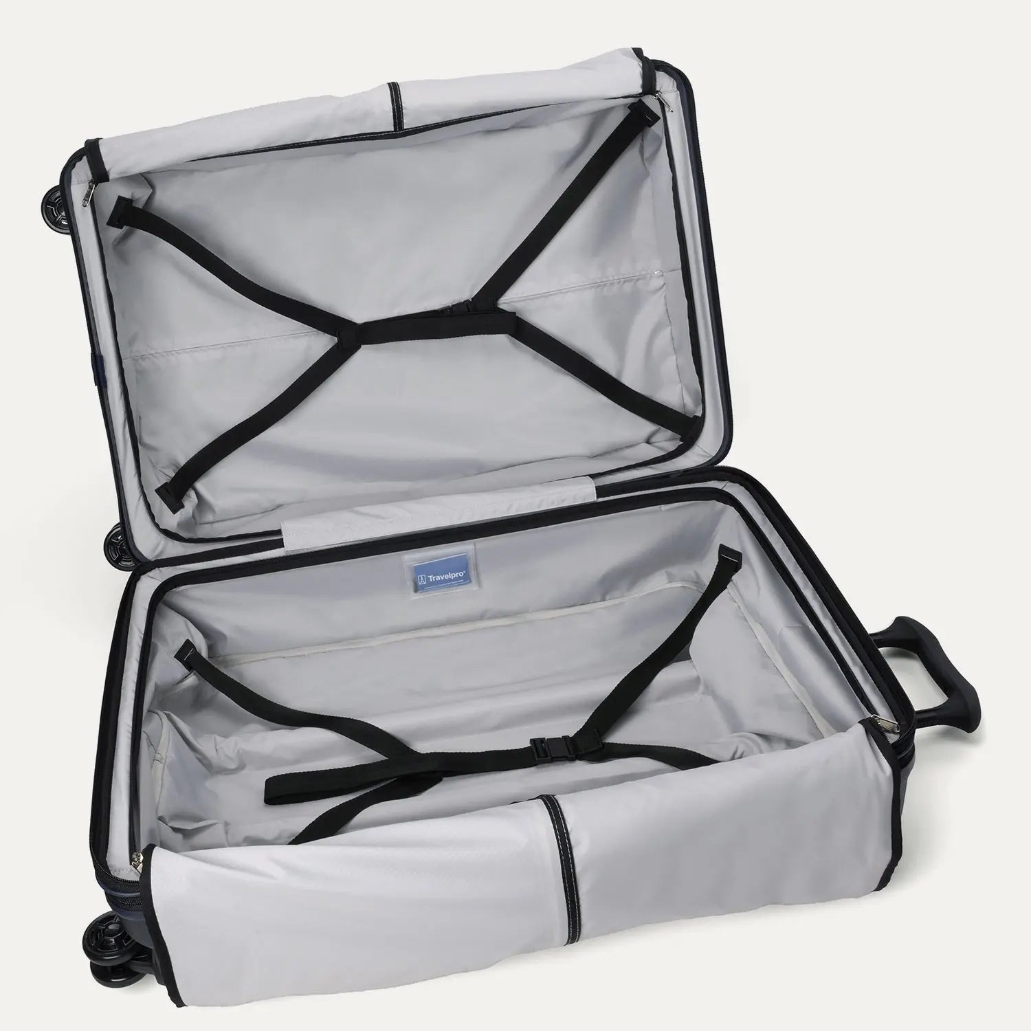 Fully open interior packing view of the Travelpro Platinum Elite Large Check-In Hardside Spinner in Aviator Navy, showing the main compartment with adjustable hold-down straps and the ECOFAB lining.